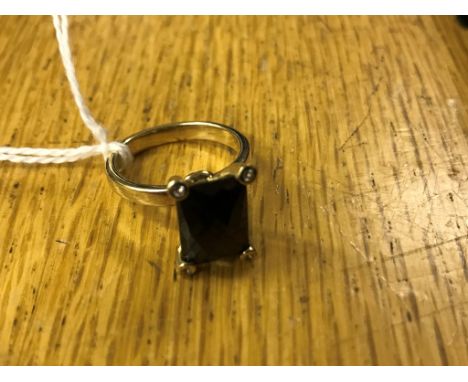 A 9ct fancy cut garnet ring with diamond set claws