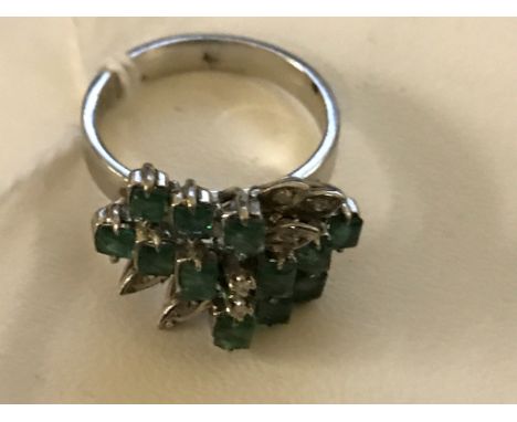 An 18k abstract stepped set emerald and diamond dress ring