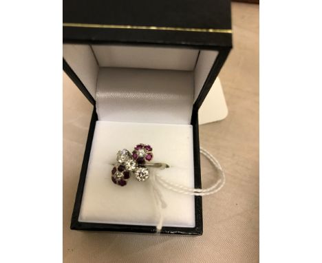 An 18ct and platinum, diamond and ruby dress ring