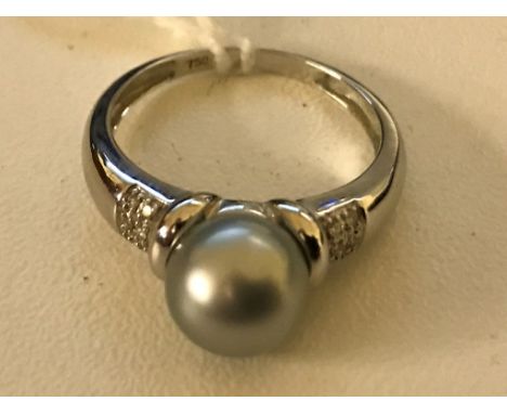 An 18ct pearl and diamond dress ring