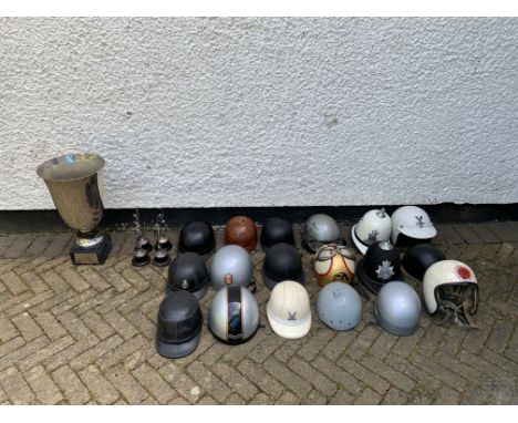 A quantity of helmetsincluding some 'pudding-basin' types, one with a caricature of Mike Hailwood, one signed and inscribed b