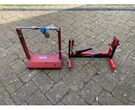 A wheel balancing standtogether with an engine mount stand, close inspection advised. (2)Footnotes:All lots are sold 'as is/w