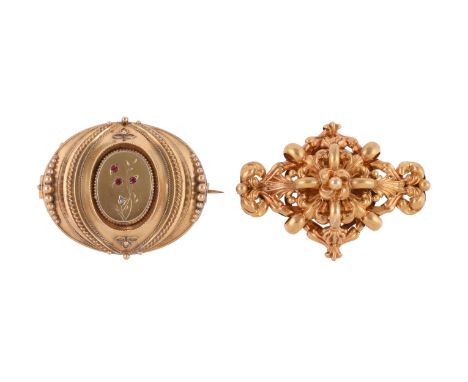 
	
		TWO VICTORIAN GOLD BROOCHES
		The first an 15 carat gold oval shaped panel with a central oval panel with red stone and 