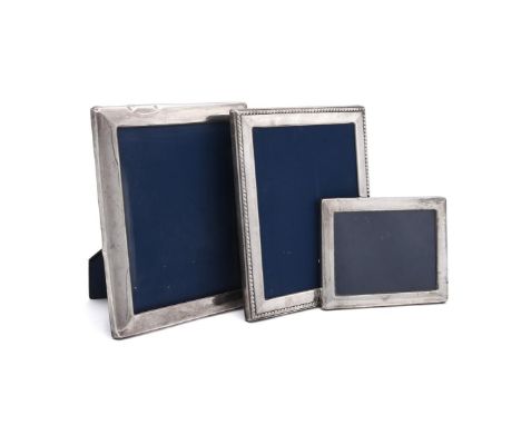 
	
		THREE SILVER MOUNTED RECTANGULAR PHOTO FRAMES
		To include: a photo frame by John Bull Ltd., Sheffield 1990, with a gadr