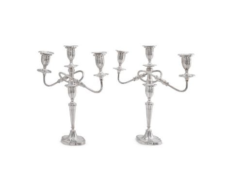 
	
		A PAIR OF SILVER THREE LIGHT CANDELABRA
		ALEXANDER SMITH, BIRMINGHAM 1957 
		With shaped oval sconces and capitals, ree