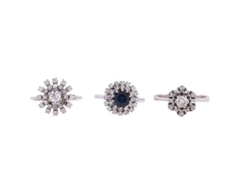 
	
		THREE GEM SET CLUSTER RINGS
		The first set throughout with brilliant cut diamonds, approximately 0.60 carats total, sta