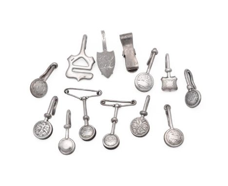
	
		THIRTEEN SILVER NAPKIN CLIPS
		VARIOUS MAKERS AND DATES
		To include: a Victorian shield shaped napkin clip by Frederick