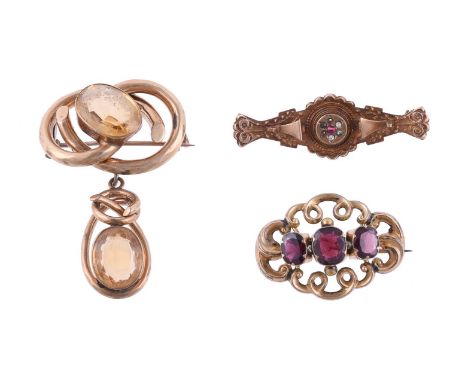 
	
		Y&nbsp;THREE VICTORIAN BROOCHES
		The first a garnet set scrolled brooch, in a gold setting, unmarked, together with a g