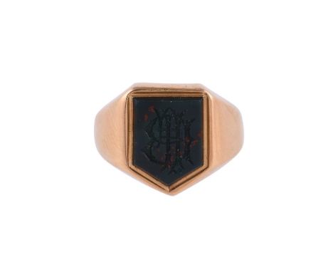 
	
		A LATE VICTORIAN 18 CARAT GOLD BLOODSTONE SIGNET RING 
		LONDON 1890
		The shield shaped panel carved with a monogram, t