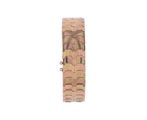
	
		A MID 20TH CENTURY TWO COLOUR BROAD TRACK LINK BRACELET
		The shaped track links with etched decoration, the concealed c