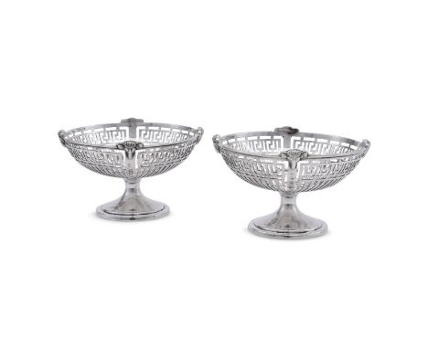 
	
		A PAIR OF SILVER PEDESTAL PIERCED DISHES
		JOAN HALL &amp; CO., LONDON 1909 AND 1910
		With ram masks to the borders, th