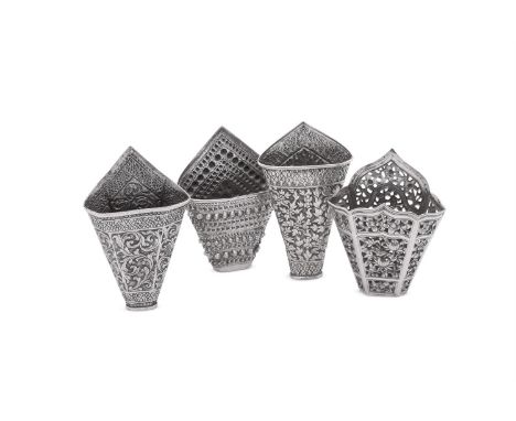 FOUR SILVER COLOURED BETEL LEAF HOLDERS To include: a Chinese silver coloured leaf holder, pierced and chased with flowers 10