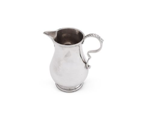 
	
		A BRITANNIA STANDARD BALUSTER CREAM JUG
		CRICHTON BROTHERS#, LONDON 1915
		With a leaf capped double scroll handle, eng