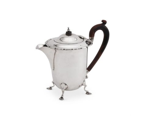 
	
		A SILVER HOT WATER JUG
		MAPPIN &amp; WEBB LTD., BIRMINGHAM 1936
		With a wood scroll handle and finial to the domed cov