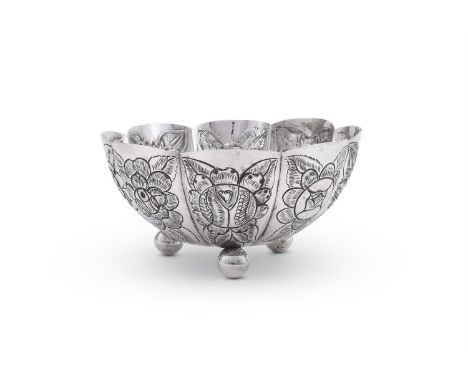 A MEXICAN SILVER SCALLOP SHAPED BOWL MONTERREY S.A, .925 STANDARD Embossed with floral sprays and on three ball feet 24.5cm (
