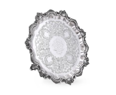 
	
		A VICTORIAN SILVER SHAPED CIRCULAR SALVER
		MARTIN, HALL &amp; CO., SHEFFIELD 1898
		With a C-scroll and foliate border,