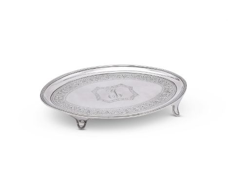 
	
		A GEORGE III SILVER OVAL TEA POT STAND
		HENRY CHAWNER, LONDON 1791
		With a reeded border, engraved with a foliate band