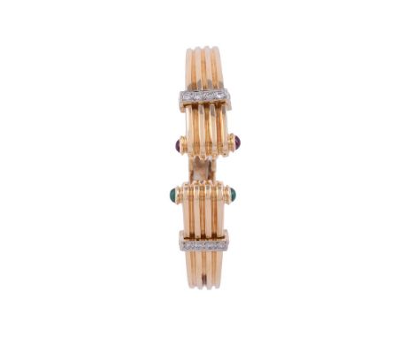 
	
		A DIAMOND, RUBY AND EMERALD HINGED BANGLE
		The reeded arms each with brilliant cut diamond set band, the terminals with
