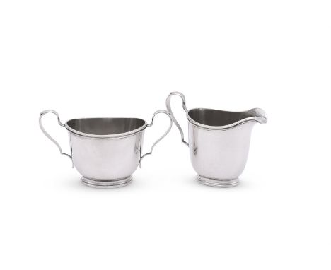 
	
		AN AMERICAN SILVER COLOURED OVAL CREAM JUG AND SUGAR BOWL
		INTERNATIONAL STERLING, NO. C112
		With double scroll handle