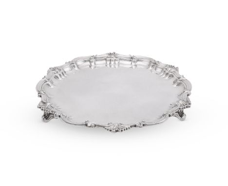 
	
		AN EDWARDIAN SILVER SHAPED CIRCULAR SALVER
		THOMAS BRADBURY &amp; SONS, LONDON 1902 
		With a foliate and scroll border