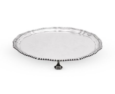 
	
		A SILVER SHAPED CIRCULAR SALVER
		ADIE BROS. LTD, BIRMINGHAM 1931
		With a gadrooned shaped circular border and on three
