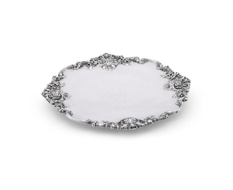 
	
		AN AMERICAN SILVER COLOURED SHAPED CIRCULAR PLATE 
		GORHAM CO., NO. 5210
		With a chased C-scroll and shell border engr