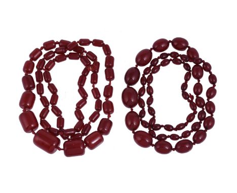 
	
		A CHERRY COLOURED BEAD NECKLACE
		The graduated oval cherry coloured beads on a knotted strand; together with a similar 