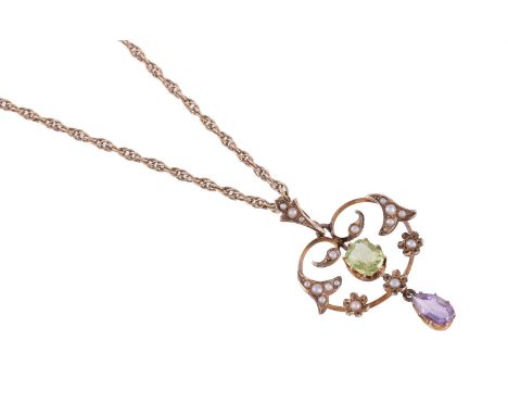 
	
		AN EDWARDIAN SUFFRAGETTE PENDANT 
		CIRCA 1910 
		The pierced foliate panel set with half seed pearls, with a central pe