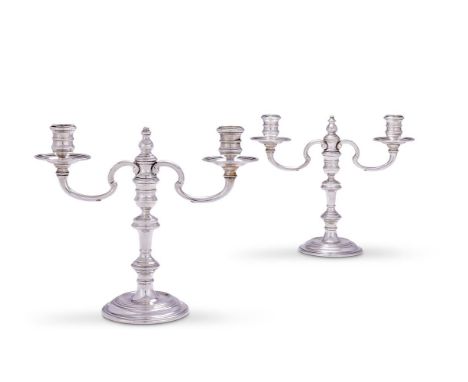 
	
		A PAIR OF SILVER TWIN BRANCH CANDLESTICKS
		WILLIAM COMYNS &amp; SONS LTD., LONDON 1960
		With turned capitals and circu