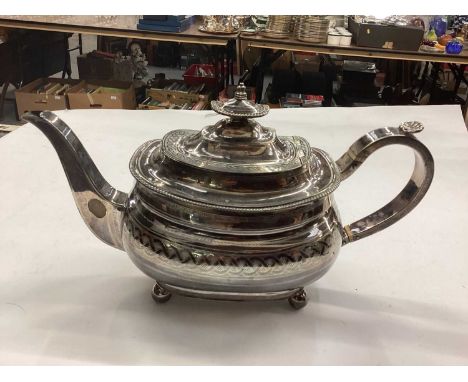 Georgian silver teapot with engraved decoration and shell thumb piece, raised on ball feet. 19oz