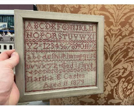 Victorian needlework alphabet sampler by Martha E Caston, Aged 11, 1879, mounted in glazed frame.