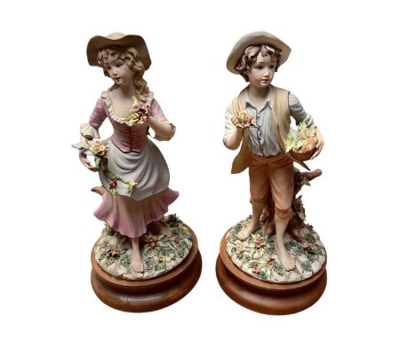 Collection of 7 Capodimonte figures including seated couple picking flowers, boy with basket of fruit, girl playing a musical