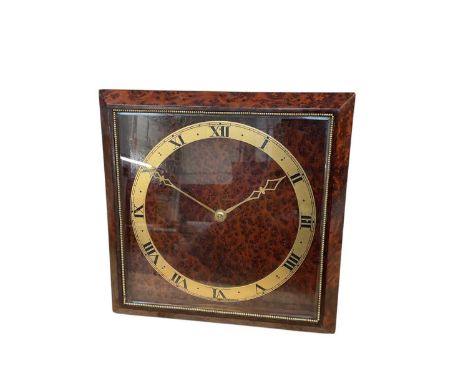 Art Deco Asprey clock with 8 day movement in a figured burr walnut bevelled glazed case with easel style stand, dial signed '