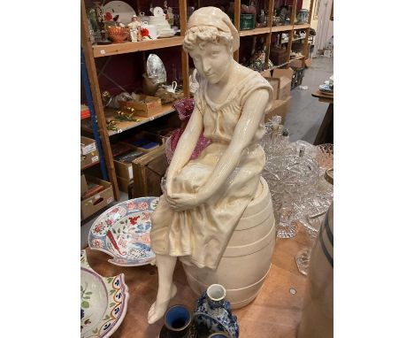 Large ceramic figure of a lady sitting on a barrel