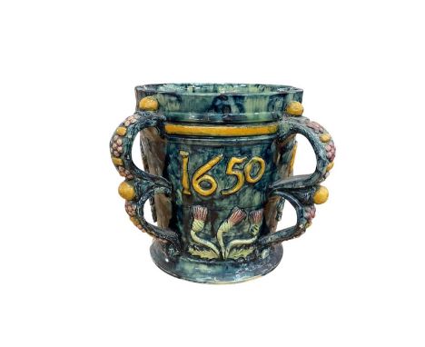 Castle Hedingham Edward Bingham blue glazed pottery four handled jug / loving cup with applied floral decoration and 1650, th
