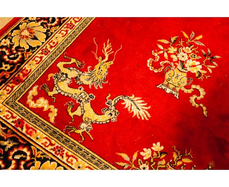 MODERN CHINESE WOOL CARPET
with central circular motif of stylised foliate and scrolling form, surrounded by floral and folia