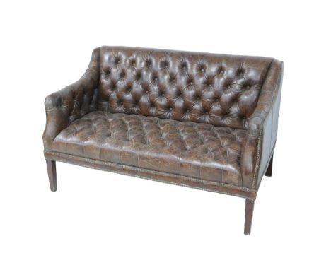 A Halo leather upholstered button back settee, raised upon tapered legs, 134 by 80 by 85cm high. 