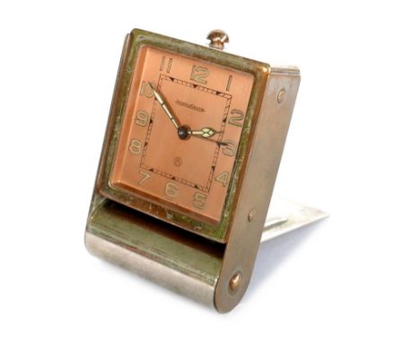A vintage Jaeger LeCoultre travel alarm clock, with eight day movement, copper coloured Arabic dial with luminous hands and n