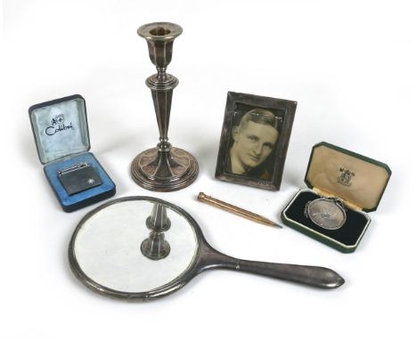 A group of mixed collectables, including a Mappin & Webb candlestick, 18cm high, a silver miniature photo frame, E Mander & S