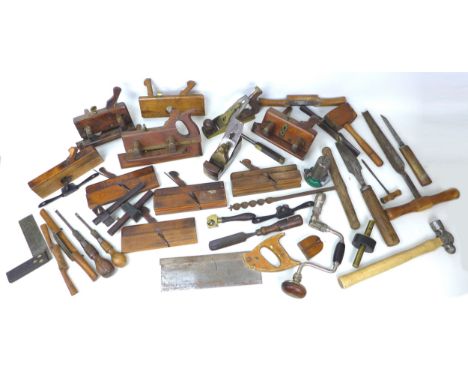 A collection of vintage wooden tools, including a Holland wood plane, housed in a metal container. (q)
