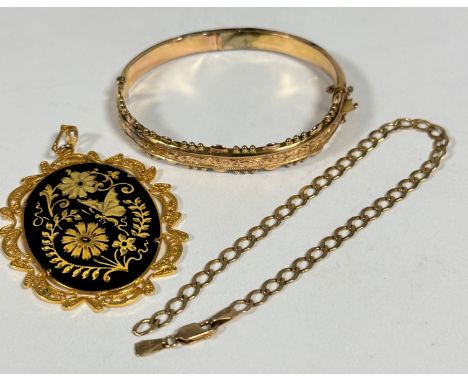 A Eastern yellow metal oval engraved pendant, (L x 6cm), an Edwardian 9ct gold hollow stiff hinged bangle, with chased front 