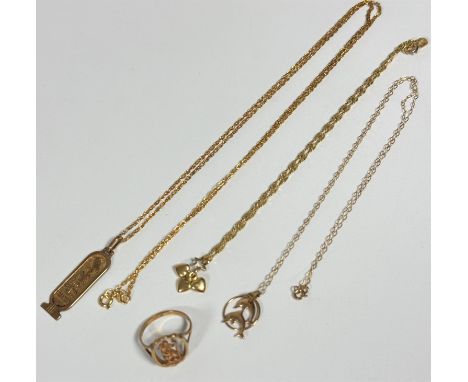 A 9ct gold Egyptian inspired pedant with hyrogliphs on trace link chain, L 33cm, a 9ct gold gold short chain with three minia