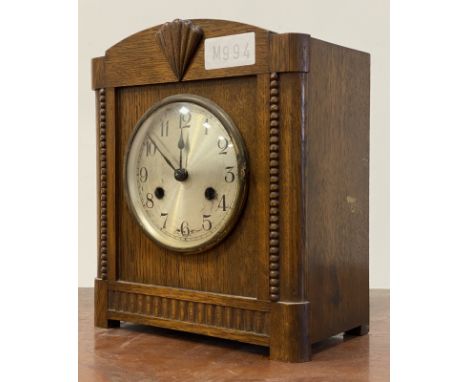 An early 20th century oak eight day mantel clock, the silvered dial with Arabic chapter ring H28cm