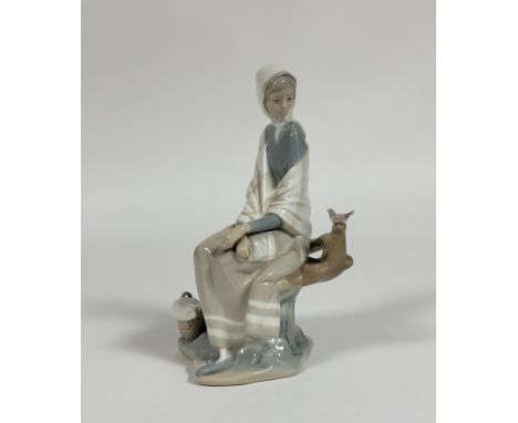 A Lladro figure of a Shepard lady sitting on a trunk looking at a bird. (h- 25.5cm) (no signs of chips or repairs) (marked ve