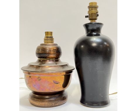 A black glazed baluster form ceramic lamp base (h- 31cm), together with a squat form wooden mounted copper lamp base (h- 22cm