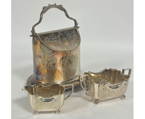 A Edwardian Epns oval biscuit barrel with swing handle to top and oval lift up panel sections to side with allover fern engra