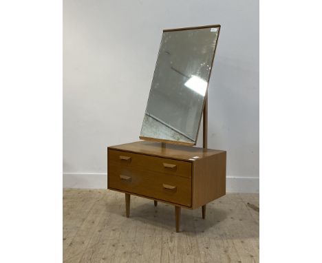 Stag, a mid century light oak veneered dressing chest, with swing mirror above two drawers, raised on turned supports H142cm,