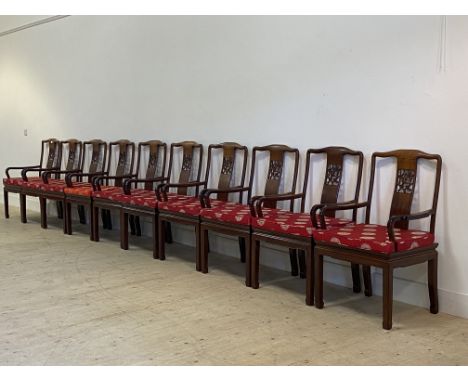 A set of ten Chinese hardwood dining chairs, with pierce carved splat back over panel seat, raised on square shaped supports 