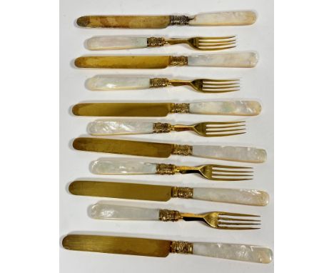 A Edwardian gilded part set of six mother of pearl handled fruit knives and five forks, ( knives L 20cm forks L 17cm) show si
