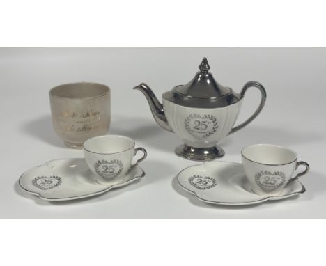 A Royal Winton Grimwades 25th Anniversary silver tea pot (h-21cm), two cups and two saucers with built in side dish(w-22cm)  